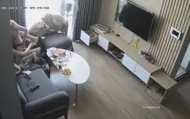 Young couple in livingroom, riding on sofa